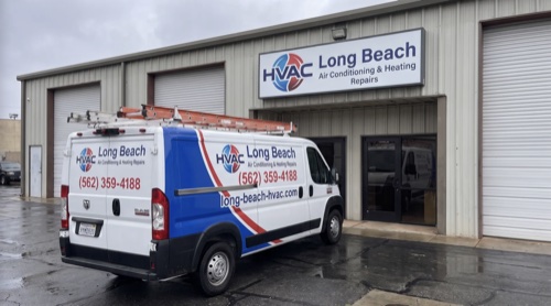 HVAC technicians servicing AC unit at residential home