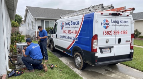 HVAC team working on outdoor AC unit in Long Beach neighborhood